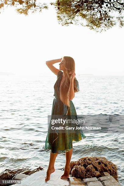 young woman in green dress by the sea - brac croatia stock pictures, royalty-free photos & images