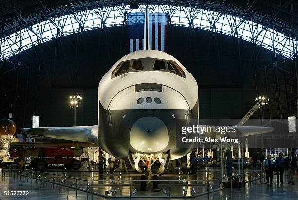 Space shuttle Enterprise is displayed during a press preview of the James S. McDonnell Space Hanger at the Smithsonian National Air and Space...