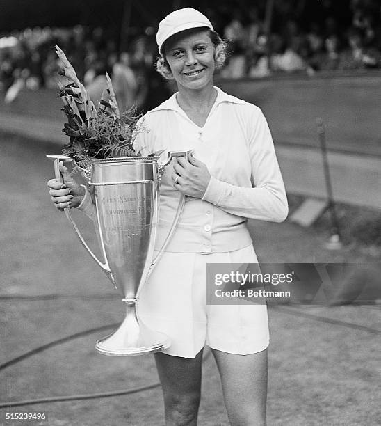 Forrest Hills, NY- Miss Alice Marble of San Francisco, is pictured with the cup emblematic of the Woman's National Singles Championship, following...