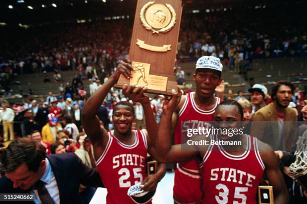 Albuquerque, New Mexico: North Carolina state basketball players hold up the NCAA Final Four Plaque after defeating Houston 54-52 in the championship.