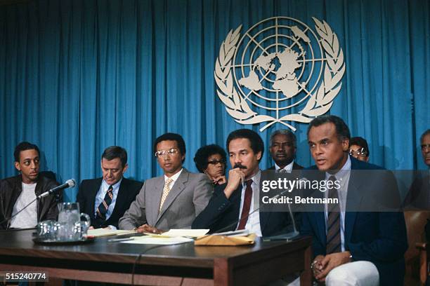 Left to right are Gregory Hines, Tony Randall, Arthur Ashe, Ruby Dee, Randall Robinson, Ossie Davis, and Harry Belafonte, speaking at a press...