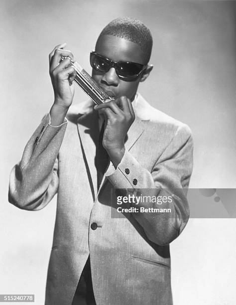 Young Stevie Wonder playing a harmonica in the 1960's.