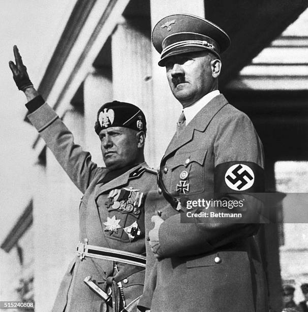 Benito Mussolini and Adolf Hitler watch a Nazi parade staged for the Italian dictators's visit to Germany.