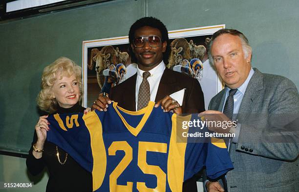 Anaheim, California: Flanked by Los Angeles Ram owner Georgia Frontiere and Rams coach John Robinson, Eric Dickerson is introduced to the media...