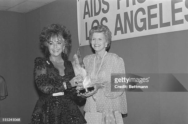Los Angeles, California: Actress Elizabeth Taylor and former First Lady Betty Ford at the "Commitment to Life" benefit dinner. Taylor presented Ford...