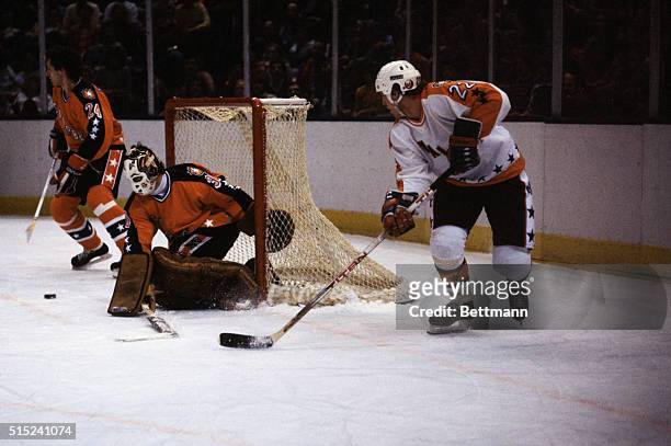 Uniondale, New York: Mike Bossy , N. Y. Islanders, playing for the Wales Conference All Stars, fires puck across the crease in front of goalie Murray...