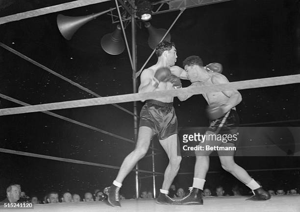 Joe Louis defeats challenger Max Schmeling during the first round of their championship match.