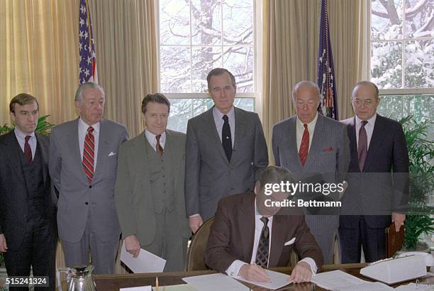 Washington, DC: President Reagan signs February 25 a request to congress asking for the transfer of funds in the Defense Department to be used for...