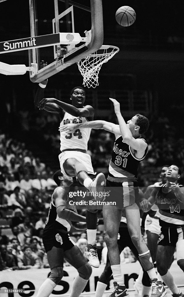 Hakeem Olajuwon and Sam Bowie Battle for Rebound