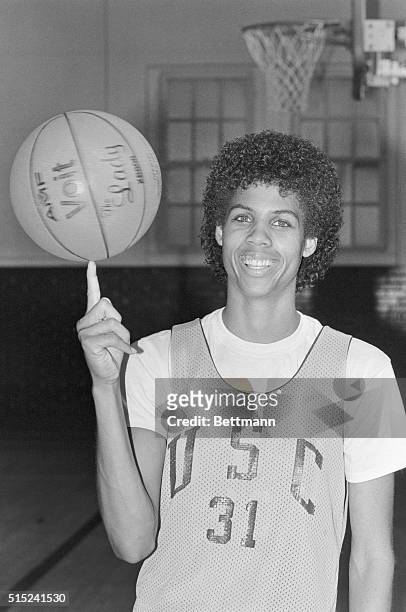 Year after her participation in the Olympics, American basketball player Cheryl Miller, in a University of Southern California jersey, . Spins a...