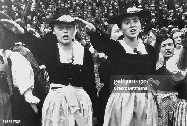 Nuremberg, Germany: Girls in Native dress give the Universal Nazi salute during the Nuremberg Party Congress which finalized Germany's campaign to...