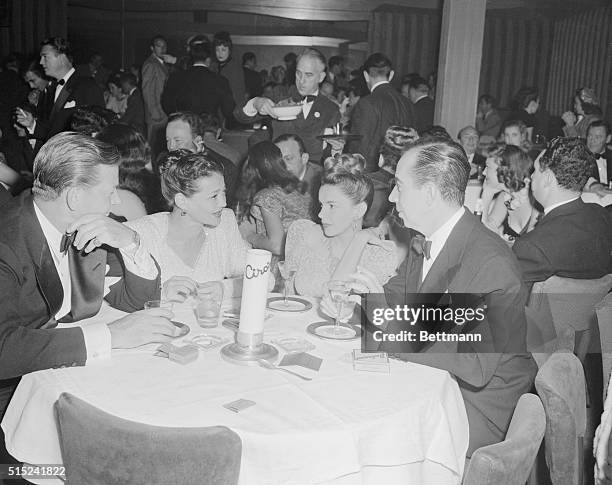 Foursome at Ciro's on Hollywood's Sunset Strip seem interested in Judy Garland's latest story. Left to right are Carlton Alsopand, his actress wife...