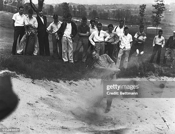 Byron Nelson, pro of the Reading, Pennsylvania, Country Club, shown blasting out of a sand trap during a practice round over the Spring Mill course...