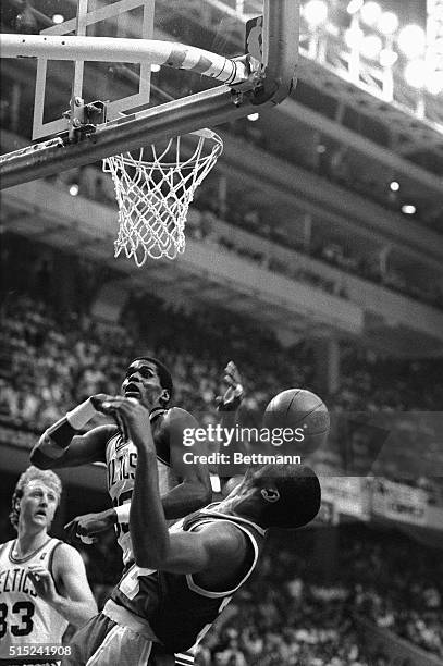 Here the ball bounces off the face of Lakers' Earvin Johnson as he battles for rebound with Celtics' Robert Parish during 3rd quarter action of Game...