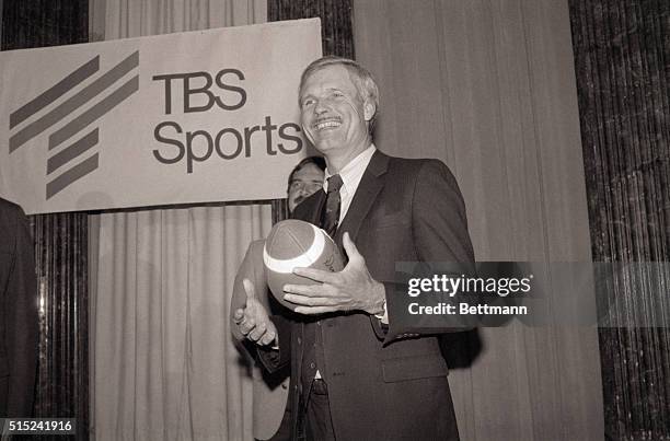 New York, New York- Ted Turner, Board Chm. And President of the Turner Broadcasting System , flips a football as he meets the press in NYC announcing...