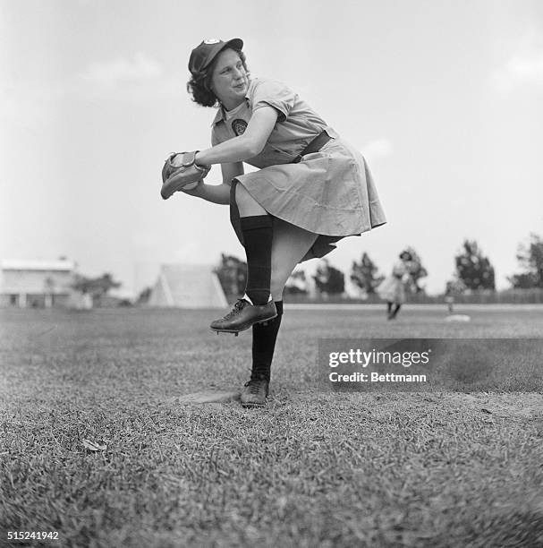 Jean Marlowe of Scranton, Pennsylvania, the pitcher for the Chicago Colleens, limbers up here, as spring training began for all the teams in the All...