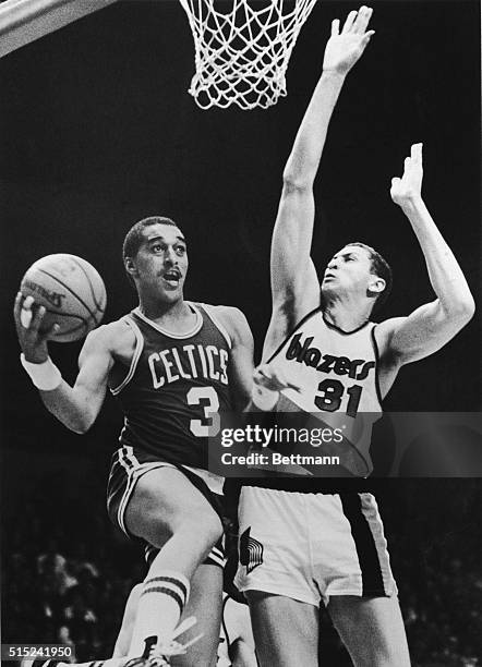 Dennis Johnson of the Boston Celtic drives for a lay up against Sam Bowie of the Portland Trailblazers during a basketball game in Portland, Oregon.