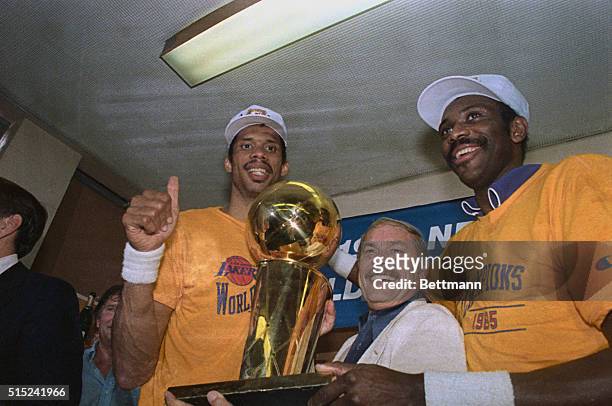 Boston: Lakers owner Jerry Buss proudly displays the Larry O' Brien NBA World Championship trophy presented to him and the team after they defeated...