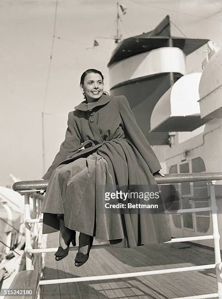 New York, New York- Vivacious Lena Horne smiles happily as she views the New York skyline from the deck of the S.S. America, which brought her to New...