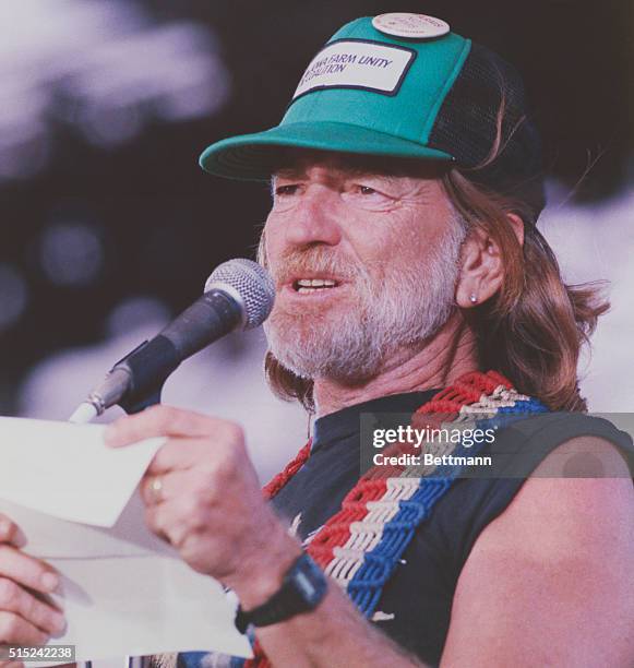 Farm Aid. Champaign, Illinois: Willie Nelson reads a letter from Jimmy Cagney expressing his support for the American farmers at the Farm Aid concert...
