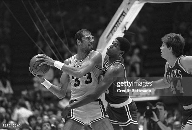 Inglewood, CA- Boston Celtic center, Robert Parish, tries to swat the ball away from Lakers', Kareem Abdul-Jabbar, during the 3rd period in the NBA...