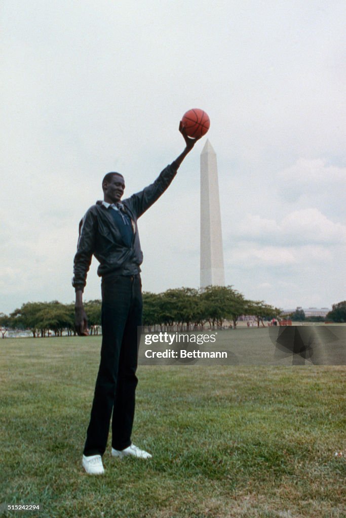Manute Bol Holding Basketball