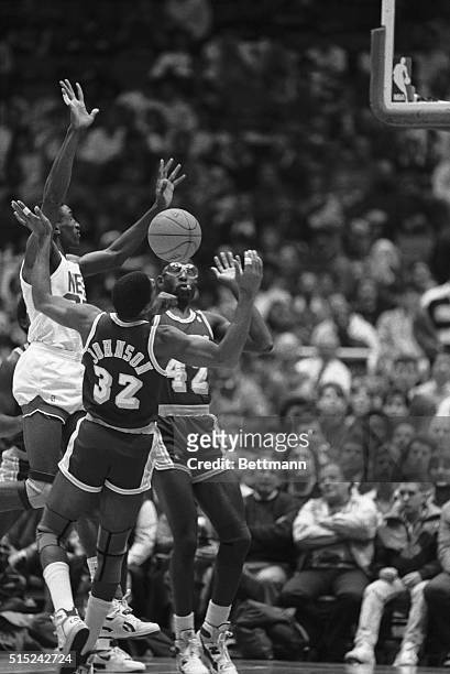 New Jersey Nets' Roy Hinson is fouled by the Los Angeles Lakers' Magic Johnson while Lakers' James Worthy goes for the loose ball in the first...