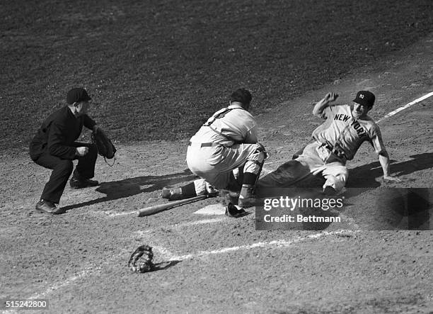 Joe DiMaggio slides into home to bring the tying run in the ninth inning of the Yankees versus the Cincinnati Reds.
