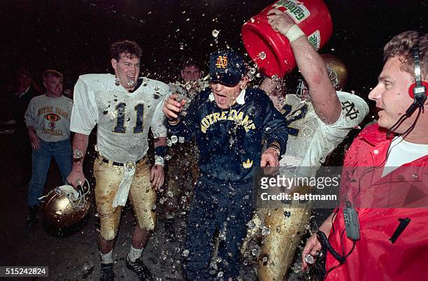 Miami: Notre Dame head coach Lou Holtz is drenched by Bryan Flannery with a bucket of icewater after his Fighting Irish defeated the Colorado...