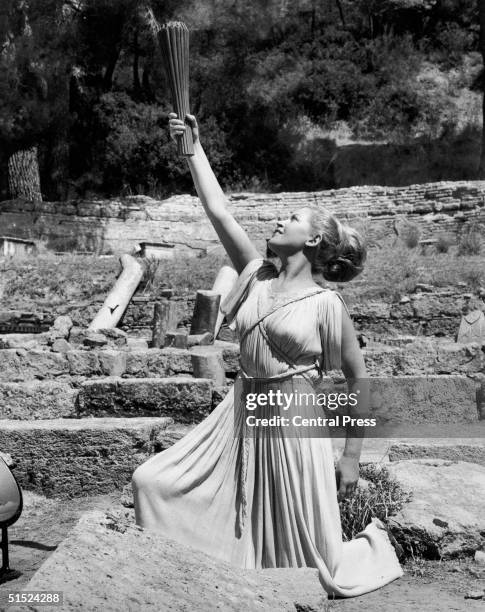 The Olympic Flame is held aloft by a 'High Priestess' at the ancient Greek city of Olympia, from where it will be carried to Mexico City for the...