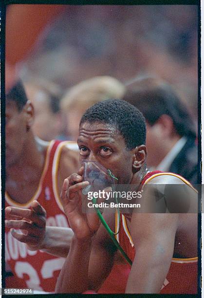 Denver: Suffering from the effects of the thin air in the Mile High City of Denver, Houston Rocket guard Eric Floyd breaths oxygen during a time out...