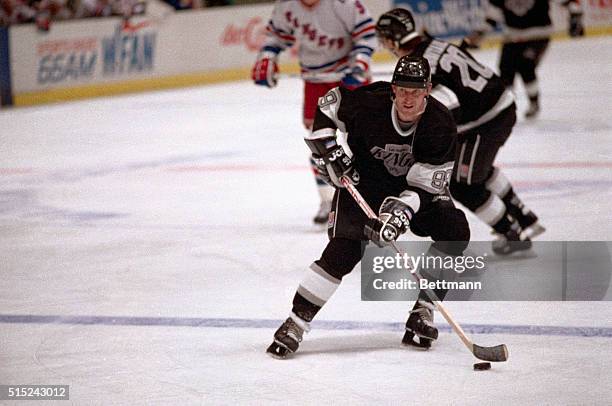 Wayne Gretzky, Los Angeles Kings' superstar stick handles the puck as he heads down the ice during the NHL game here 12/12 against the New York...