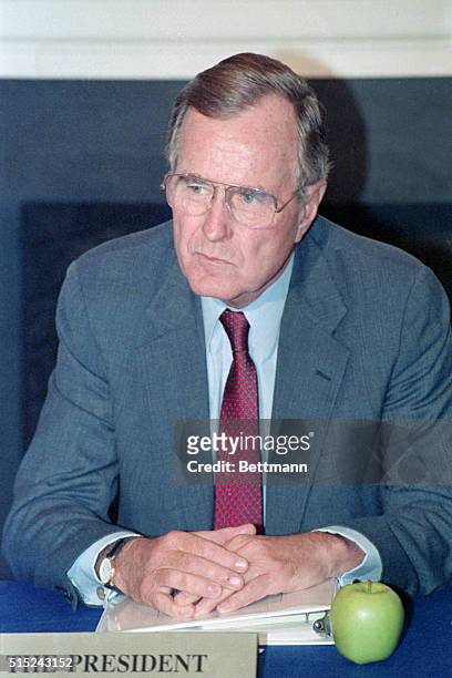 Charlottesville, PA- United States President George Bush, with an apple at his side listens to governors give their suggestions during the 3rd...