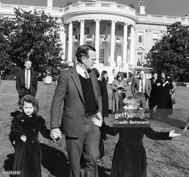 President George H. W. Bush holds hands with his granddaughters, Barbara and Jenna, on the south lawn of the White House, Washington, DC, 21st...