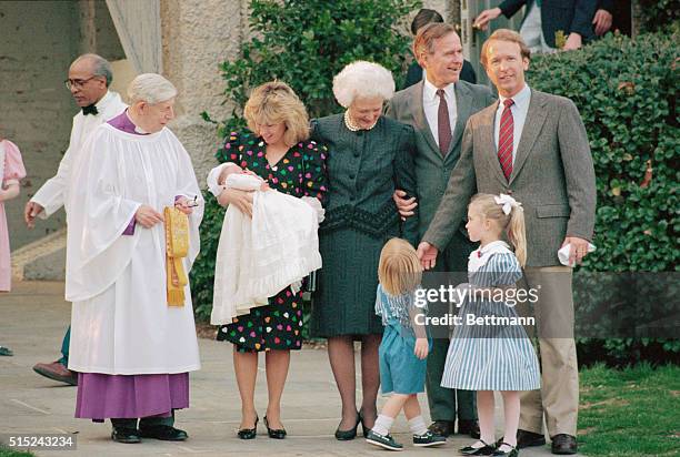 Washington, DC: Grandparents, President and Mrs. Bush, look on a Sharon Bush holds her seven-week old daughter Ashley following her christening 3/26...