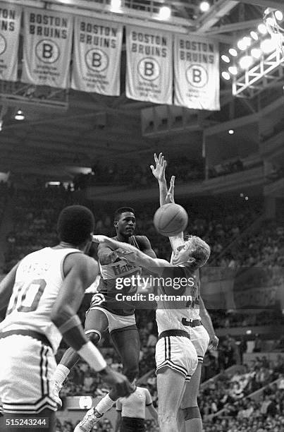 Hawks' Dominique Wilkins passes off as Celtics' Larry Bird guards Wilkins closely in the first quarter of the game at Boston Garden 1/22.