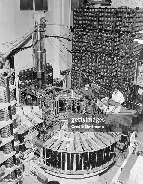 University of Michigan physicist, Dr. H.G. Crane, and George Grover, a research associate, check the new 15-ton 000,000 electrron-volt synchrotron...