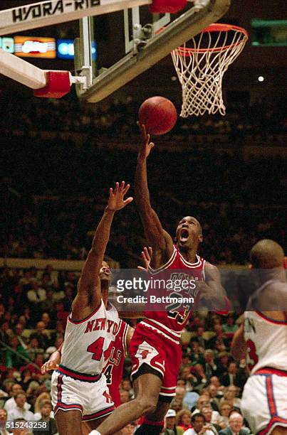 Chicago Bulls' Air Jordan takes off as he eludes Sidney Green, of the New York Knicks, to make a driving layup in the first period of their NBA...
