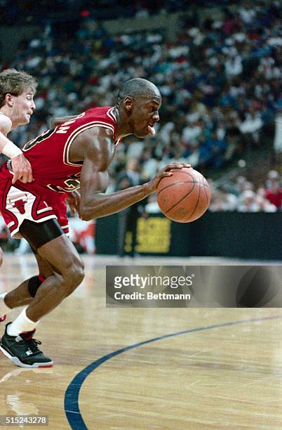Chicago's Michael Jordan drives past Cleveland's Mark Price on his way to a layup during second period action, with the Cavs leading the Bulls at the...