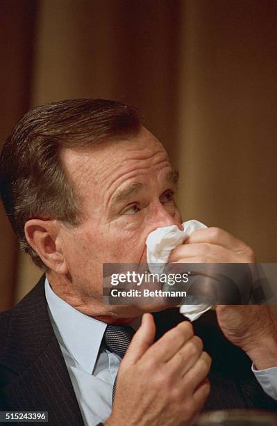 Washington: president Bush uses his handkerchief 2/2 while attending the National Prayer breakfast.