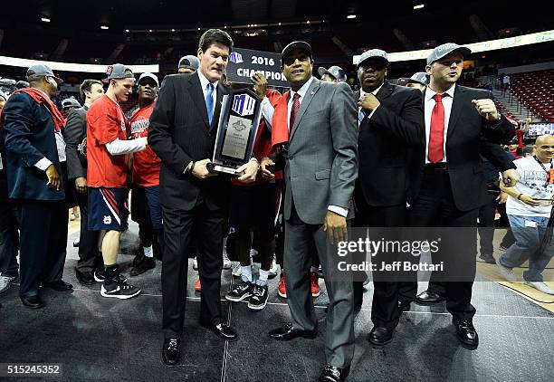 Mountain West Conference Commissioner Craig Thompson presents the Mountain West Conference championship trophy to head coach Rodney Terry of the...