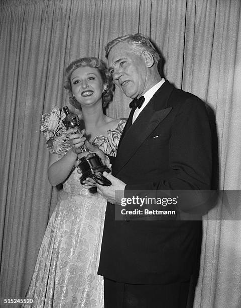 Actress Celeste Holm presents the Best Supporting Actor Oscar to Walter Huston during the 1949 Academy Awards presentation. Huston received the award...