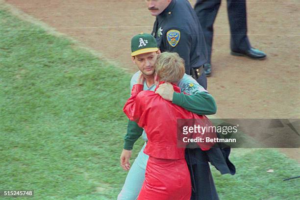 San Francisco: Oakland A's Terry Steinbach hugs his wife after an earthquake cancelled game 3 of the World Series 10/17.