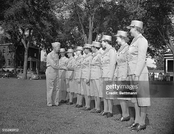 The first eight girls to receive their WAAC uniforms at Fort Des Moines are welcomed into the Women's Army by Col. Don C. Faith, Fort Commandant....