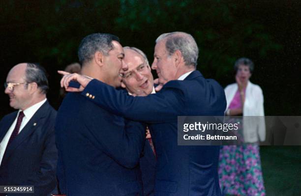 Camp David, Md.: Secretary of State James Baker huddles with Secretary of Defense Dick Cheney and Chairman of the Joint Chiefs of Staff Colin Powell...