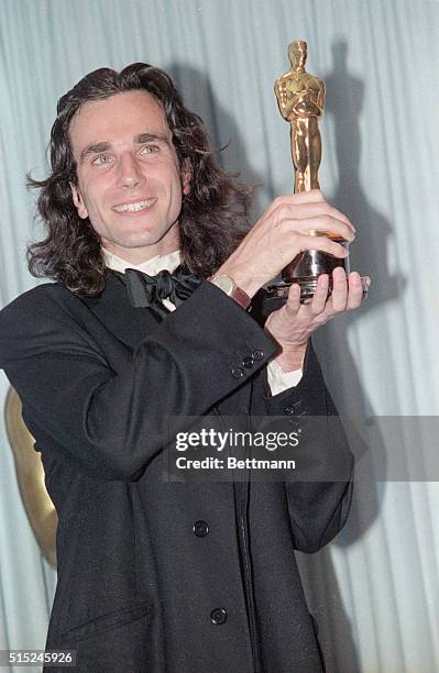 Los Angeles: Best actor Daniel Day Lewis holds up his Oscar for My Left Foot 3/26.
