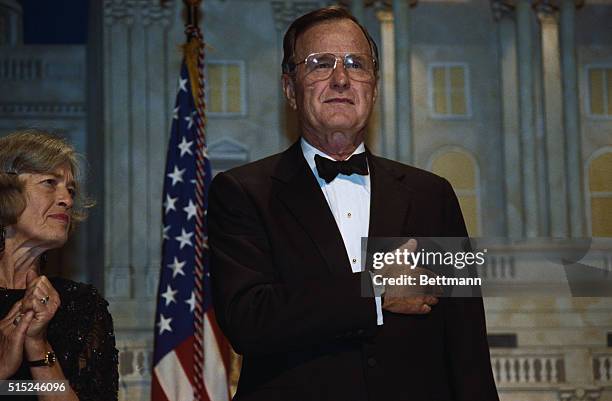 Washington: President Bush recites the Pledge of Allegiance during "The President's Dinner" at the Washington Convention Center.