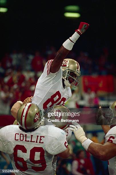 San Francisco 49ers wide receiver Jerry Rice is lifted by teammates after catching his second touchdown pass of Super Bowl XXIV 1/28.