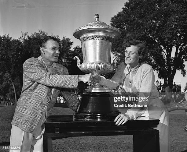 Ben Hogan, left, and Babe Zaharias exchange congratulations at Tam O'Shanter Country Club where they each won World Championship of Golf titles...