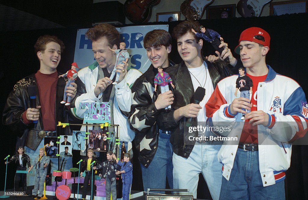 New Kids on the Block Holding Dolls